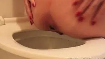 The girl pooping in a toilet bowl. Close-up 5
