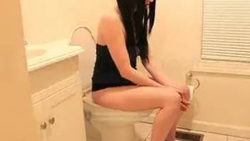 Pooping brunette in toilet