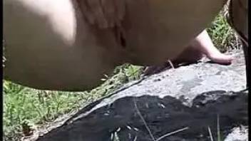 A girl pissing in nature