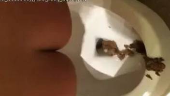 The girl quickly pooping in the toilet