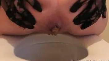 The girl pooping in a toilet bowl. Close-up 3