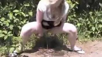 Girl pissing near the road