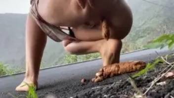 Woman pooping on the road somewhere in the mountains