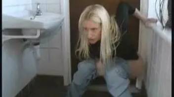 The girl pisses on the floor in the toilet