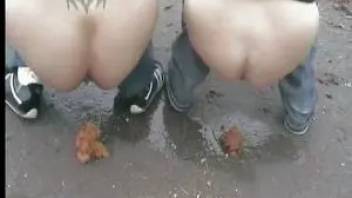Two girls shitting on the wet road