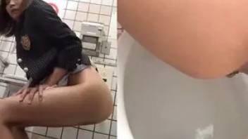 Cute asian girl pushing and pooping in the toilet