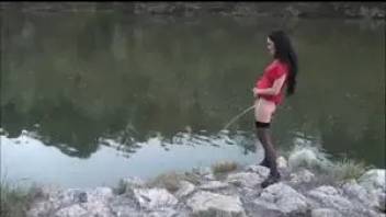 Girl pissing in standing water
